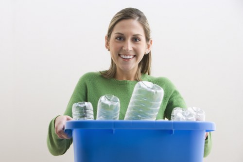 Workers loading mixed waste from a terraced house clearance in Mottingham